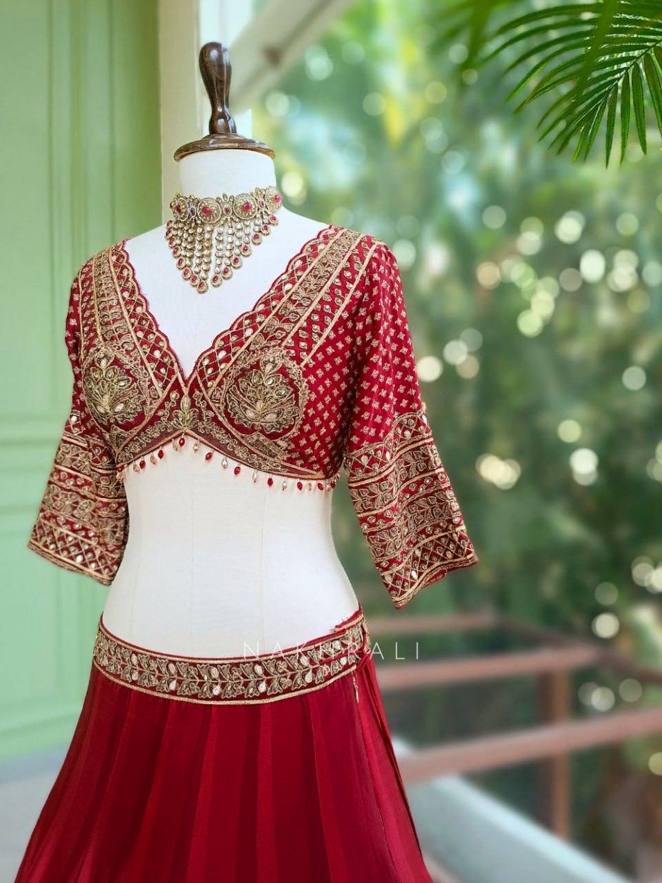 Regal Crimson Red Bridal Lehenga Choli Ensemble Featuring Intricate Gold Zari Embroidery, Heritage Motifs, and Embellished Tassels